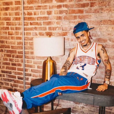 Lil Pump Wearing A Blue Hat With A White Sixers Jersey Blue Track Pants And White Sneakers