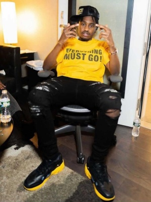 Lil Tjay Wearing A Chrome Hearts Trucker With A Gallery Dept Yellow Tee Amiri Jeans And Raf Simons Sneakers