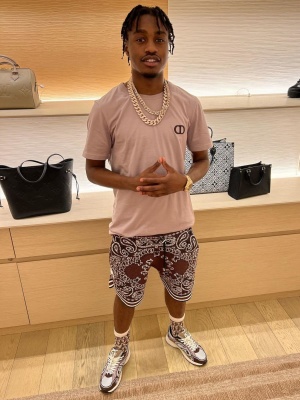 Lil Tjay Wearing A Dior Cd Icon T Shirt With Amiri Brown Bandana Shorts And Dior B29 Sneakers