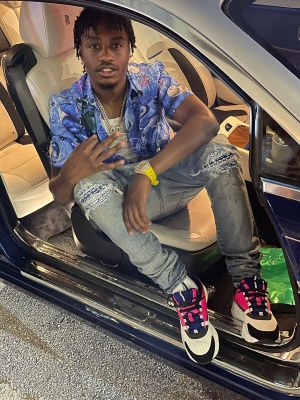 Lil Tjay Wearing A Dior X Kenny Scharf Sea Life Swirl Print Shirt With Amiri Jeans And Dior Neon Pink Purple And White B22 Sneakers