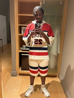 Lil Tjay Wearing A Gucci Hockey Jersey And Mesh Shorts With White And Grey Sneakers