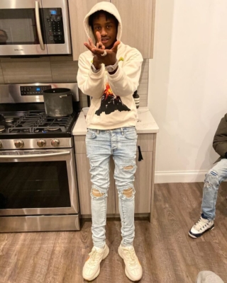 Lil Tjay Wearing A Gucci Hoodie And Amiri Jeans