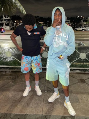 Lil Tjay Wearing A Versace Hoodie And Track Shorts With Whtie And Yellow Alexander Mcqueen Sneakers