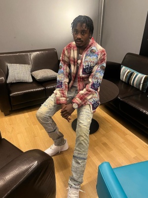 Lil Tjay Wearing A Who Decides War Red Flannel Cardigna And Jeans With Nike Af1s