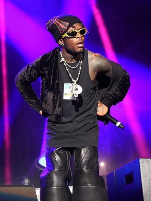 Lil Uzi Vert Wearing A Balenciaga Tank Top With A Velour Hoodie Black Biker Jeans And Leopard Sunglasses