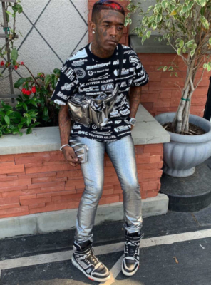 Lil Uzi Vert Wearing A Black Louis Vuitton T Shirt With Metallic Pants Metallic Wallet And Metallic Purse With Louis Vuitton Sneakers