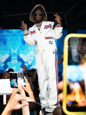 Lil Uzi Vert Wearing A Gucci Sun Hat Sunglasses Cardigan Trackpants And Run Sneakers