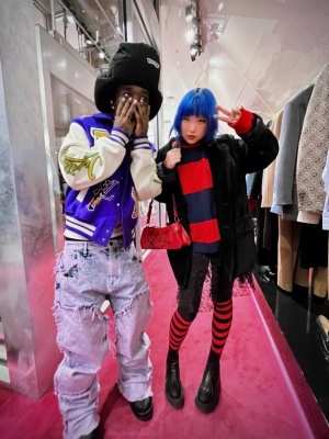 Lil Uzi Vert Wearing A Louis Vuitton Black Padded Hat With A Blue Varsity Jacket And Frayed Monogram Carpenter Pants
