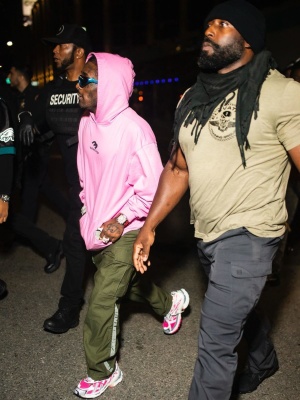 Lil Uzi Vert Wearing Balenciaga Blue Sunglasses With A Pink Hoodie And Pink Sneakers