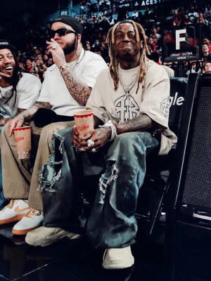 Lil Wayne Wearing A Balenciaga Metal Bb Tshirt With Destroyed Jeans And Beige Rubber Sneakers