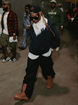 Lil Wayne Wearing A Balenciaga Unity Logo Hat With A Black Zip Hoodie Black Cargo Pants And Louis Vuitton Boots