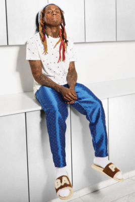 Lil Wayne Wearing A White Saint Laurent Allover Star Print T Shirt Pleasures Blue Optical Pants And Bape X Ugg Slides