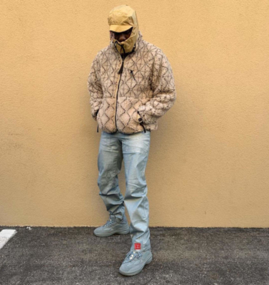 Lil Yachty Wearing A Beige Sherpa Fleece Jacket With Chanel Pants A Gold Alyx Hood And House Blue Yeezy Desert Boots