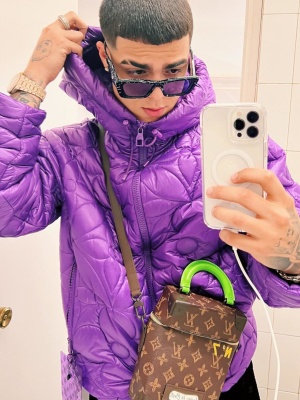 Lunay Wearing Prada Sunglasses With A Louis Vuitton Purple Lvse Monogram Jacket And Vertical Trunk Bag