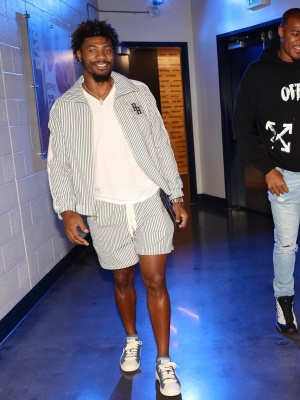 Marcus Smart Wearing A Rhude X Puma Pinstripe Jacket And Shorts And Blue Low Top Sneakers