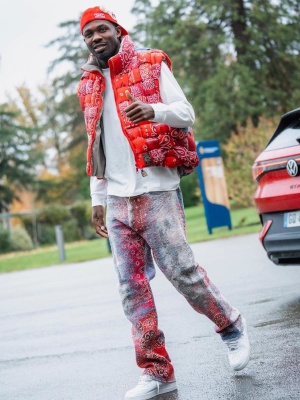 Marcus Thuram Wearing A Gallery Dept Hat With A Kapital Puffer Vest Boro Jeans And Nike Sneakers