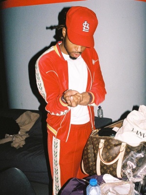 Metro Boomin Wearing A Casablanca Red Tracksuit With A Cardinals 59fifty And Lv Bag