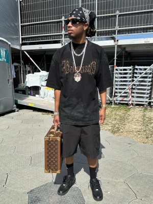 Metro Boomin Wearing Prada Sunglasses With A Balenciga Tee Louis Vuitton Briefcase And Nike Af1s