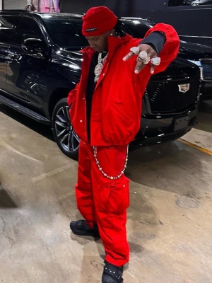 Moneybagg Yo Wearing A Balenciaga Red Ski Jacket And Ski Pants With Black Sneakers
