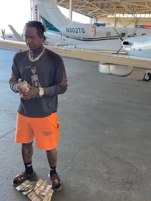 Moneybagg Yo Wearing A Gallery Dept Thermal And Orange Sweatshorts With Dior X Cactus Jack Sandals