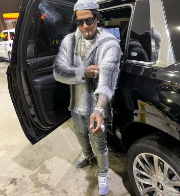 Moneybagg Yo Wearing A Louis Vuitton Beanie With A Celine Stirped Hoodie And Jordan 11 Sneakers