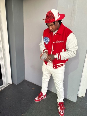 Moneybagg Yo Wearing A Louis Vuitton Everday Hat With A Red Varsity Jacket And Red Skateboarding Sneakers