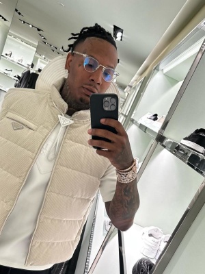 Moneybagg Yo Wearing A Prada Corduroy Down Vest With A White Hoodie And Chrome Hearts Glasses