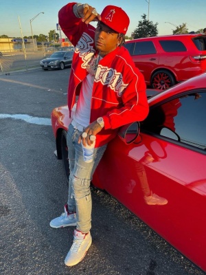 Moneybagg Yo Wearng A New Era Angels Hat With A Supreme Jacket Jeans And Jordan 5 Sneakers