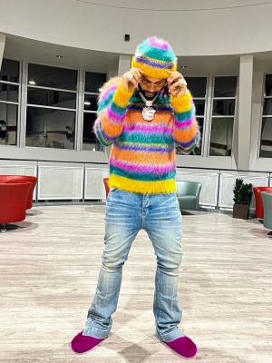 Moneyman Wearing A Marni Multicolor Striped Beanie And Hoodie With Amiri Clay Indigo Flared Jeans And Marni Fur Mules