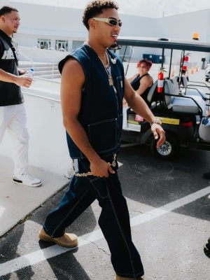 Myke Towers Wearing A Carhartt Wip Vest And Jeans With Givenchy Sunglasses