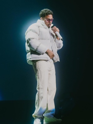 Myke Towers Wearing A Supreme X Bb Simons Puffer Jacket And White Side Studded Jeans