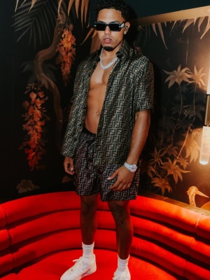 Myke Towers Wearing Fendi Sunglasses With A Brown Ff Silk Shirt And Shorts