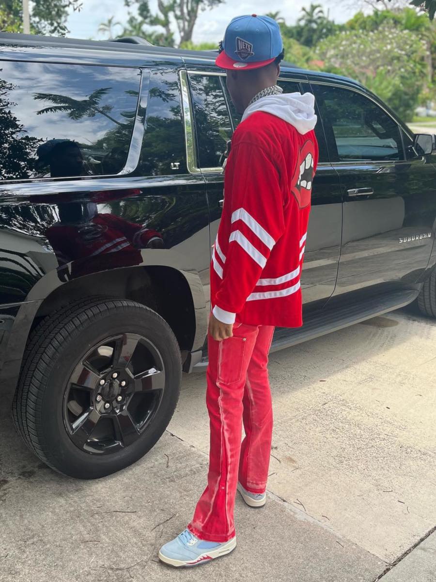 Nardo Wick Wearing a Red Hockey Jersey & Flared Jeans With Jordan 5s