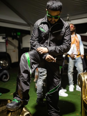 Nav Wearing A Bottega Veneta Track Jacket And Trackpants With Green Sunglasses And Black Boots