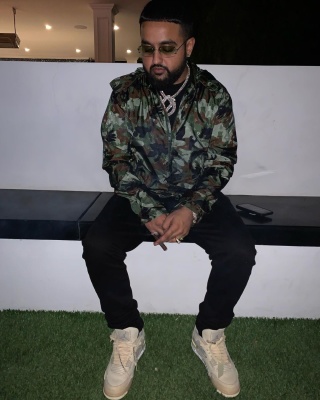 Nav Wearing A Louis Vuitton Camo Windbreaker With Black Jeans And Jordan X Off White Sail Sneakers