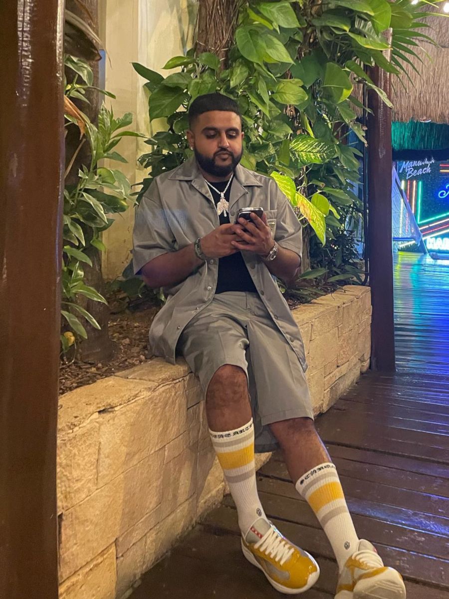 Nav Relaxes In Cancun In a Prada Shirt & Shorts With America's Cup Sneakers