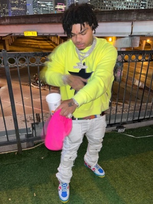 Nocap Wearing A Palm Angels Yellow Hoodie With White Jeans And Gucci Basket Sneakers