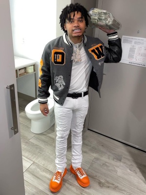 Nocap Wearing An Off White Varsity Jacket With A Black Gucci Belt And Orange Alexander Mcqueen Sneakers