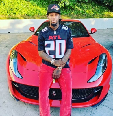 Offset Leans On His Ferrari In New Atl Falcons Jersey Red Needles Trackpants And Atl Braves Hat