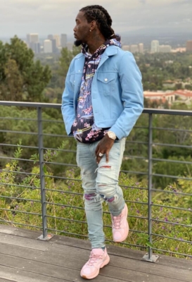 Offset Wearing A Blue Denim Jacket With A Dior Hoodie Amiri Multicolor Underpatch Jeans And Pink Dior Sneakers