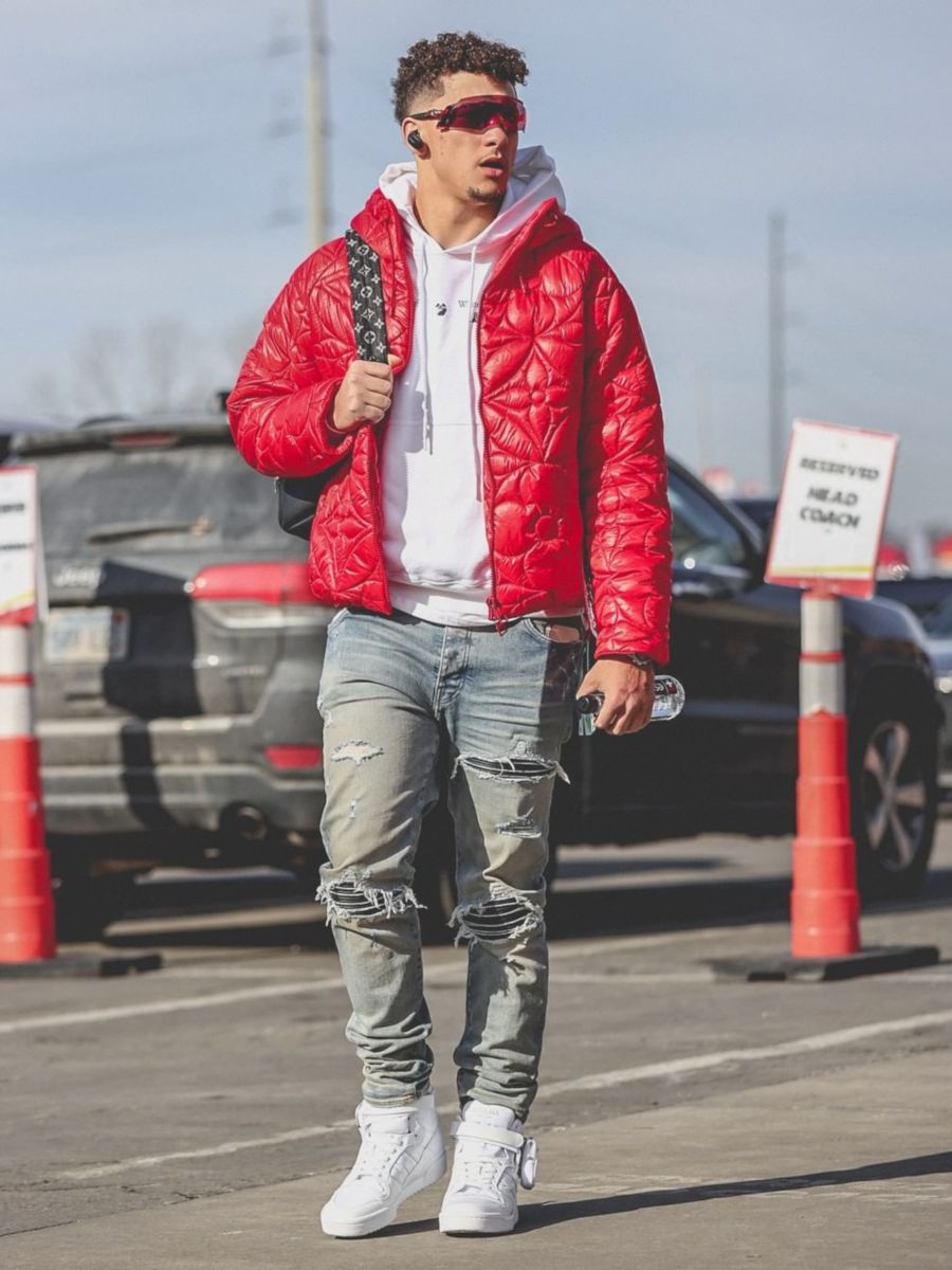 Patrick Mahomes Arrives at The 2022 AFCCG In a Louis Vuitton Backpack & Jacket With Amiri Jeans