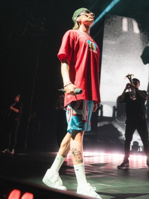 Peso Pluma Wearing A Supreme Kurt Cobain Tee With Light Blue Shorts Nike Socks And Sneakers