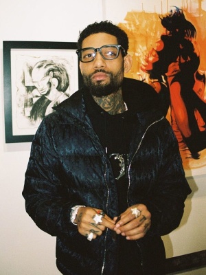 Pnb Rock Wearing A Dior Oblique Puffer Jacket And Black Dior Flowers Hoodie