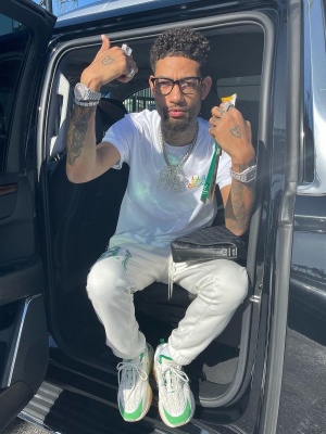 Pnb Rock Wearing An Amiri Tee Sweatpants And Snekaers With A Louis Vuitton Bag