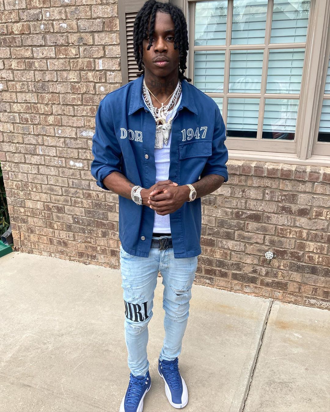 Polo G Relaxes On Vacation In Amiri, Louis Vuitton, & Jordan Outfits