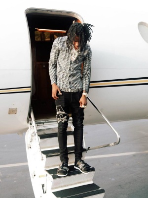 Polo G Wearing A Dior Overshirt With A Dior Oblique Belt Amiri Varsity Jeans And Dior Alpha Sandals