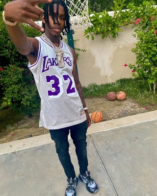 Polo G Wearing A Silver Magic Johnson Jersey And Matching Louis Vuitton Sneakers