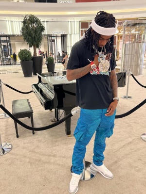 Polo G Wearing An Amiri Heart Tee With Louis Vuitton 2054 Cargo Pants And White Sneakers