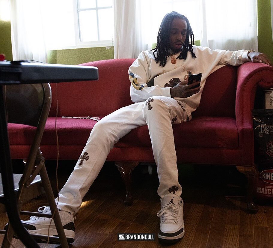 Quavo Relaxes In Jesus Is King Merch, Chrome Hearts Jeans, & Rolex Presidential