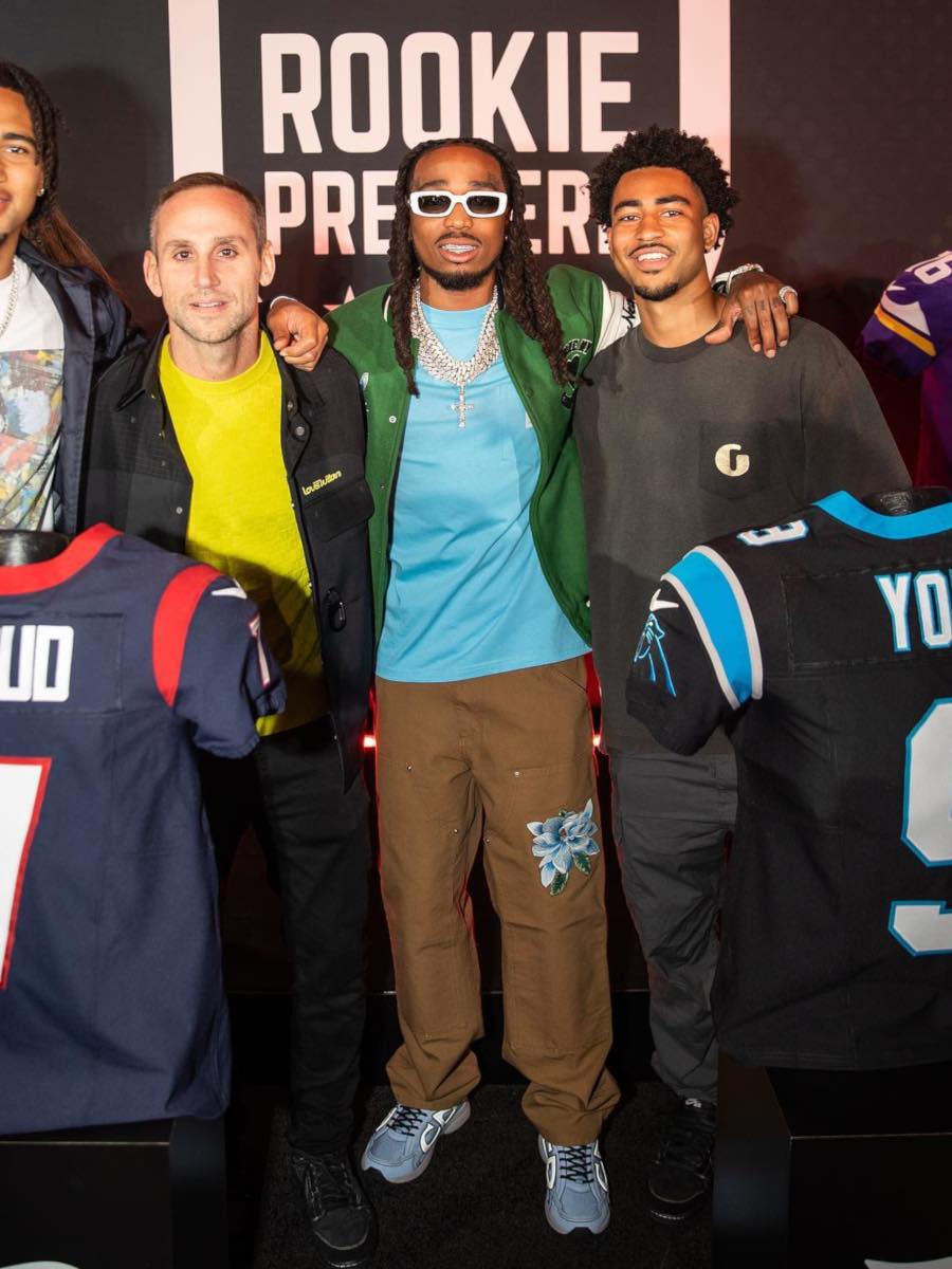 Quavo Wearing an Awake NY x Carhartt Green Jacket With a Blue Tee & Brown Pants